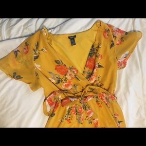 Long yellow and floral slit, v-neck dress with a tie.  Flowey and comfortable!